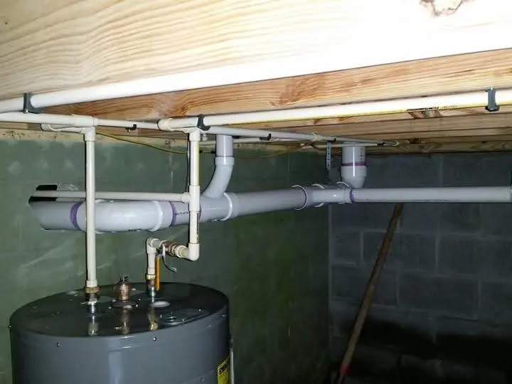 Crawlspace water heater tank with PVC and copper piping