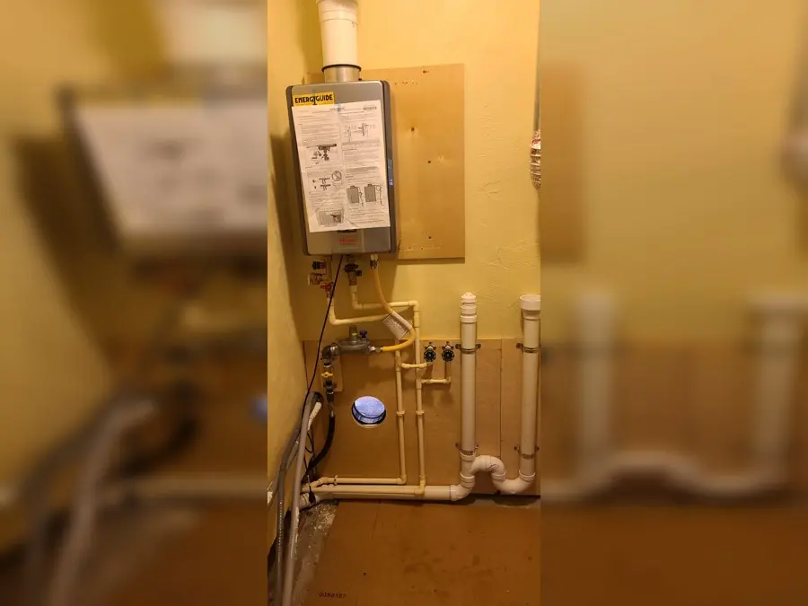 Tankless water heater installed in a utility room