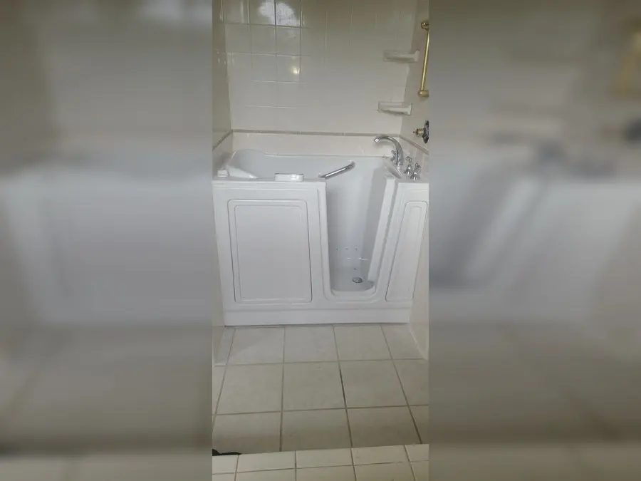 White walk-in tub on a tile floor